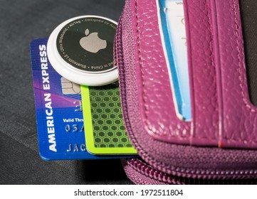 Morgantown, WV - 12 May 2021: Apple AirTag device inserted into the small credit card wallet to track its location