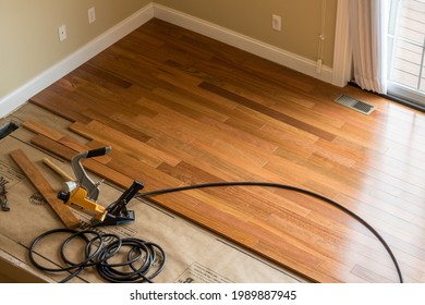 Morgantown, WV - 7 June 2021: Bostitch Nailing Gun Ready To Install Brazilian Cherry Tropical Hardwood Flooring