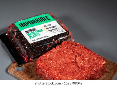 MORGANTOWN, WV - 8 October 2019: Packaging For Impossible Foods Burger Made From Plants With Raw Product On Steel Background