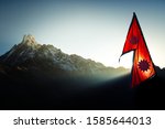 Moring sunrise hits the mountain peak and the flag of nepal.