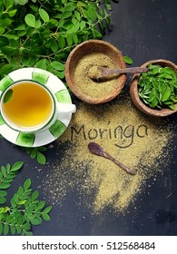 Moringa Oleifera tea with powder on table written moringa wording