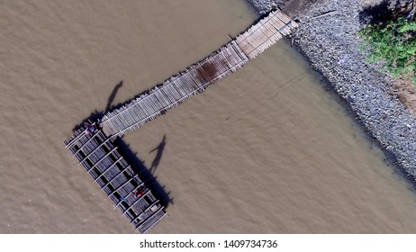 Morning Activity In A River With Wooden Raft As A Traditional Transportation To Cross The River View From Above With Aerial Drone