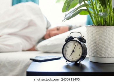 Morning Alarm Clock and Sleeping Person
