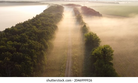 Morning autumn fog between the trees over the railway tracks - Powered by Shutterstock