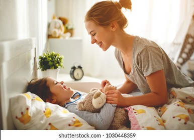 morning awakening. mother wakes her daughter in bed in morning
 - Powered by Shutterstock