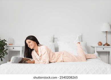 Morning of beautiful woman reading magazine in bedroom - Powered by Shutterstock