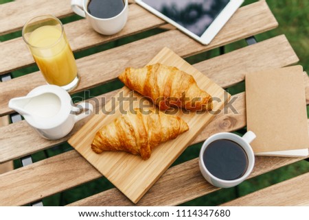 Similar – Image, Stock Photo Morning Breakfast In Green Garden With French Croissant, Coffee Cup, Orange Juice, Tablet and Notes Book On Wooden Table