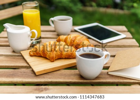 Similar – Image, Stock Photo Morning Breakfast In Green Garden With French Croissant, Coffee Cup, Orange Juice, Tablet and Notes Book On Wooden Table