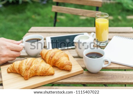 Image, Stock Photo Morning Breakfast In Green Garden With French Croissant, Coffee Cup, Orange Juice, Tablet and Notes Book On Wooden Table