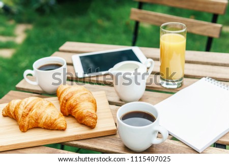 Similar – Image, Stock Photo Young And Attractive Woman Having Morning Breakfast In Green Garden With French Croissant, Donuts, Coffee Cup, Orange Juice, Tablet and Notes Book On Wooden Table