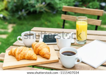 Image, Stock Photo Morning Breakfast In Green Garden With French Croissant, Coffee Cup, Orange Juice, Tablet and Notes Book On Wooden Table