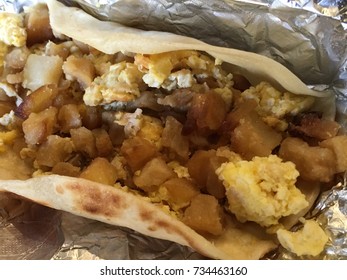 Morning BreakFast Taco With Scrambled Eggs And Bacon And Potatoes  On Foil 