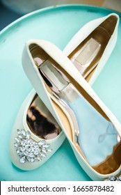 The Morning Of The Bride. Wedding Ballet Flats Shoes Of The Bride On A Blue Round Table