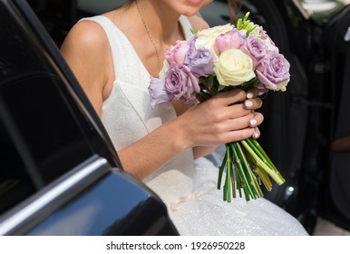 Morning Of The Bride . Wedding Bouquet In The Hands Of The Bride, Who Sits In A Black Car.