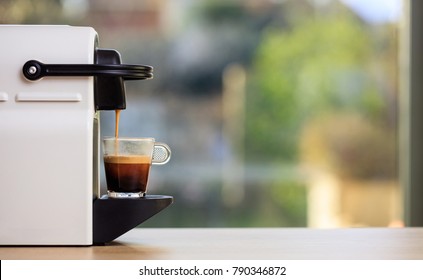 Morning Capsule Coffee. Espresso Maker Machine On A Wooden Table. Blurred Background, Space For Text, Front View