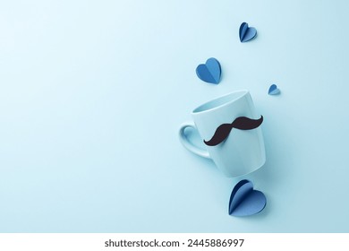 Morning Cheer for Dad: Whimsical mustache-adorned mug amidst blue heart cutouts on a calming backdrop, ideal for festive Father's Day greetings - Powered by Shutterstock