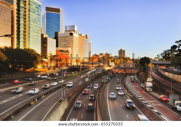 Morning city traffic on\
Warringah freeway in Sydney between North Sydney high-rises - daily\
commuters.
