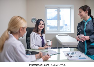 Morning In Clinic. Doctors In Neurologycal Clinic Talking While Having Shift Change