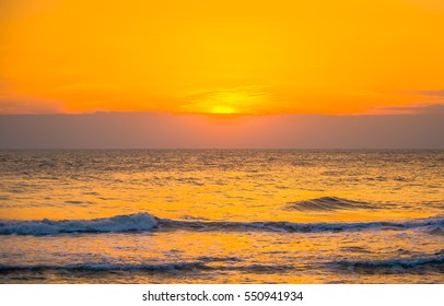 Morning clouds and sun with a wave of the sea. - Shutterstock ID 550941934