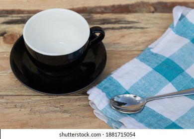 Morning Coffee With Blue Tea Towel And Iron Spoon On Wooden Table