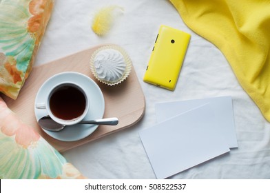 Morning Coffee Concept: Cup Of Coffee And Cell Phone In A Bed With Empty Cards With Copy Space; Top View, Flat Lay.
