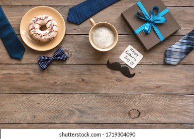 Morning coffee, donut, gift box with greeting card, Father's Day celebration concept. Happy Fathers Day flat lay on wooden desk, copy space, banner.  - Powered by Shutterstock