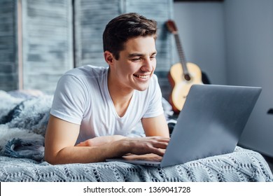 Morning concept! Beautiful, pretty man sitting by internet on his laptop. - Powered by Shutterstock