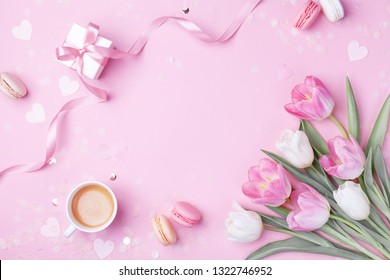 Morning cup of coffee, cake macaron, gift or present box and spring tulip flowers on pink background. Beautiful breakfast for Women day, Mother day. Flat lay. - Powered by Shutterstock