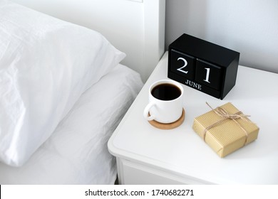 Morning cup of coffee, gift present, black wooden calendar on bedside table on Happy Fathers Day. Holiday concept - Powered by Shutterstock