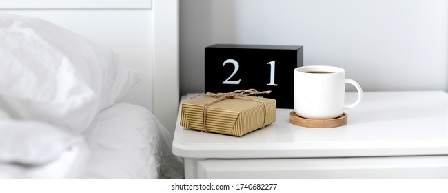 Morning cup of coffee, gift present, black wooden calendar on bedside table on Happy Fathers Day. Holiday concept - Powered by Shutterstock