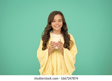 Morning Or Evening. Feeling Comfortable At Home. Happy Girl With Tea Cup. Good Morning Drink. Small Kid Blue Background. Little Girl Drink Cocoa Or Milk Before Sleeping. Cosy And Fluffy Pajama.