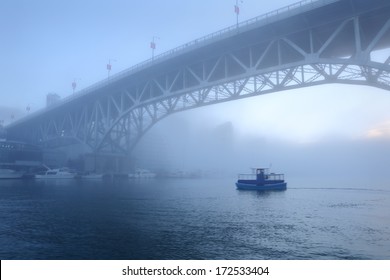 Morning Fog, False Creek, Vancouver. Early morning fog rolls under the Granville Bridge over False Creek in downtown Vancouver. British Columbia, Canada. 