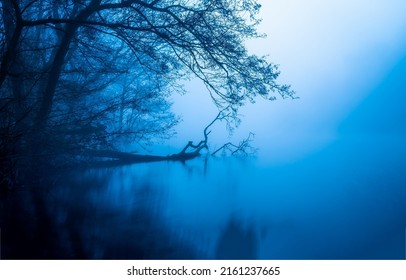 Morning fog over the forest river. Early morning blue fog over water. Blue fog on water in the morning. Morning blue fog on water - Shutterstock ID 2161237665