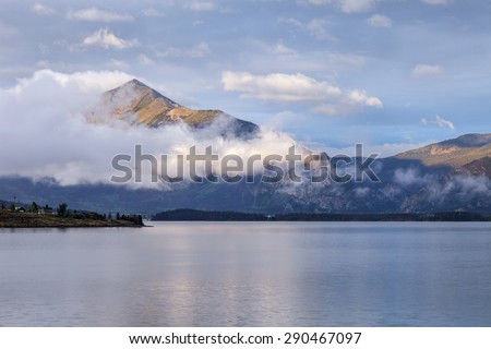 morning fog rising over calm Lake Dillon in Colorado Rocky Mountains
