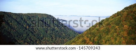 Morning fog at sunrise in autumn mountains of West Virginia in Babcock State Park