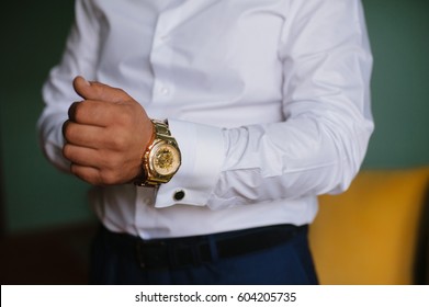 Morning groom. Morning businessman. The man wears a gold watch