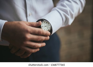 Morning of the groom. man checking time on his wrist watch. morning before wedding ceremony. - Powered by Shutterstock