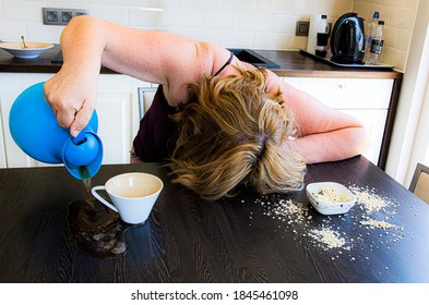 Morning hangover, monday mood, feeling of hard daily work.  Woman with a hard knock life spills cofee and oatmeal in kitchen on table.  Artistic setup of working people life.