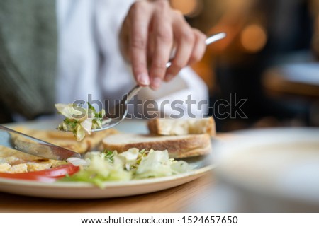 Morning healthy breakfast. Woman eating omelet with fresh vegetables