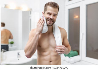 Morning hygiene, Handsome man in the bathroom looking in mirror - Powered by Shutterstock