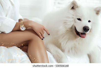 Morning Image Of Glamour Girl Posing With Her Dog In Bed,fashion Details,gold Watch With Sparkles On Her Hand,women's Accessories 