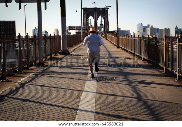Morning jog across the bridge on the background of\
New York