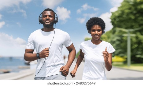 Morning Jog. Young African American Couple Running Or Trotting Along River Bank. - Powered by Shutterstock