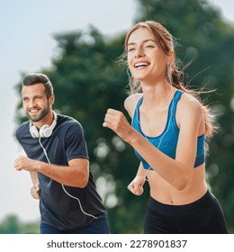 Morning jogging. Happy excited young couple, runners running together, woman train with man, or bearded fit coach exercising outdoors. Fitness, sport city marathon workout concept. Square image - Powered by Shutterstock