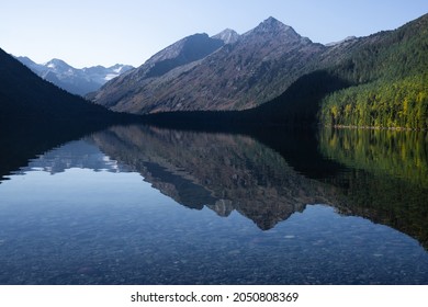 morning landscape of alpine lake with reflection in water