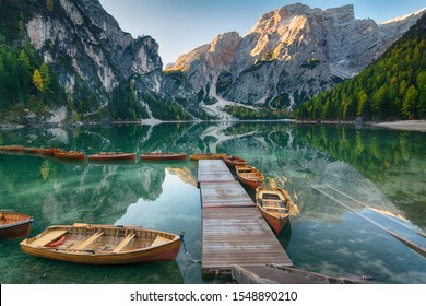 Morning landscape of autumn picturesque mountain lake in Dolomites Alps on blue sky background