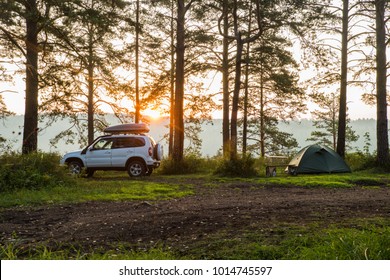 Morning Landscape With Tent And All-wheel Drive Car, Dawn And Forest In The Background. Summer Camping. Tourism.