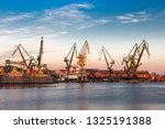 Morning landscape - view of the shipyard with historical cranes in the industrial part of the city Gdansk (Gdańsk) in Poland (Polska). The shipyard is close to the old town. Peaceful Motlawa river.