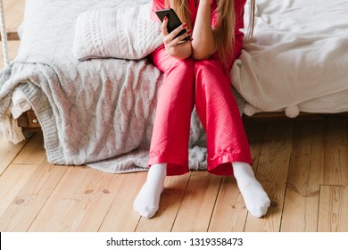 Morning Leisure Time. Woman Sitting On Bed With Smartphone.