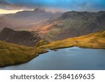 Morning light on Lake District mountains overlooking Stickle Tarn, UK.